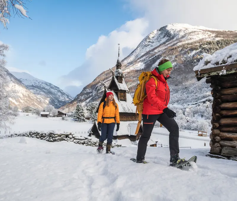 Two people on a snowshoe hike on Kongevegen, by Borgund Stave Church