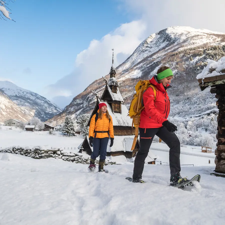 Two people on a snowshoe hike on Kongevegen, by Borgund Stave Church