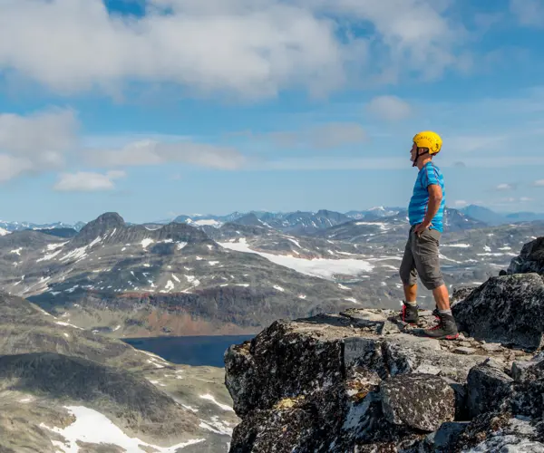 Summit hike with guide from Tyin Aktiv – participant looks at the view from the top of Falketind 