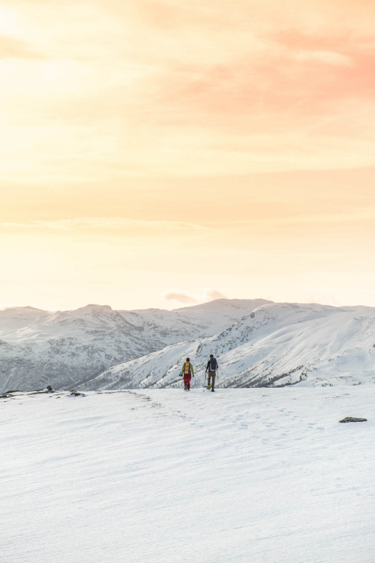 Two people on snowshoes in beautiful evening sun at Tyin Filefjell