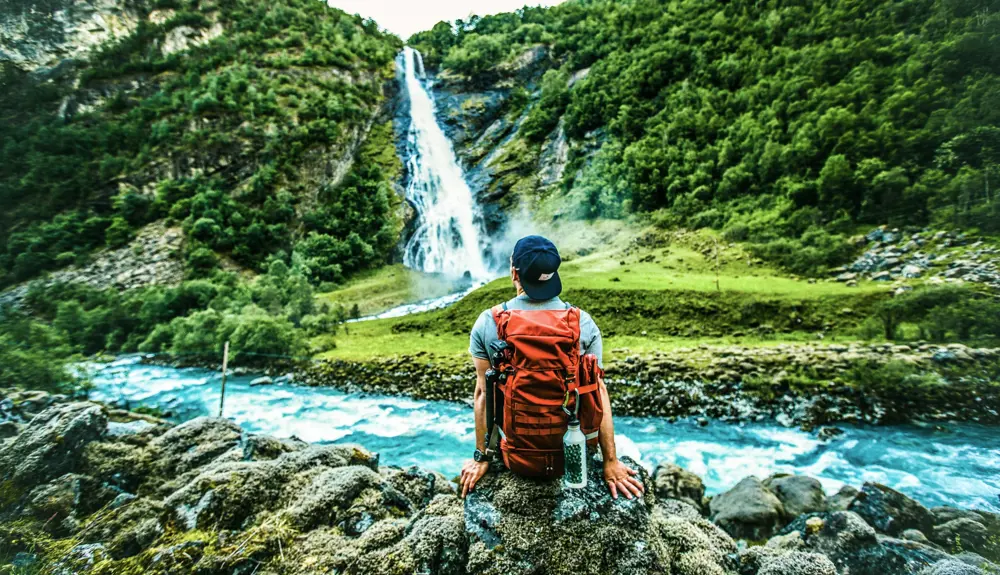 Turgåer ser på Vettisfossen i Utladalen, Årdal